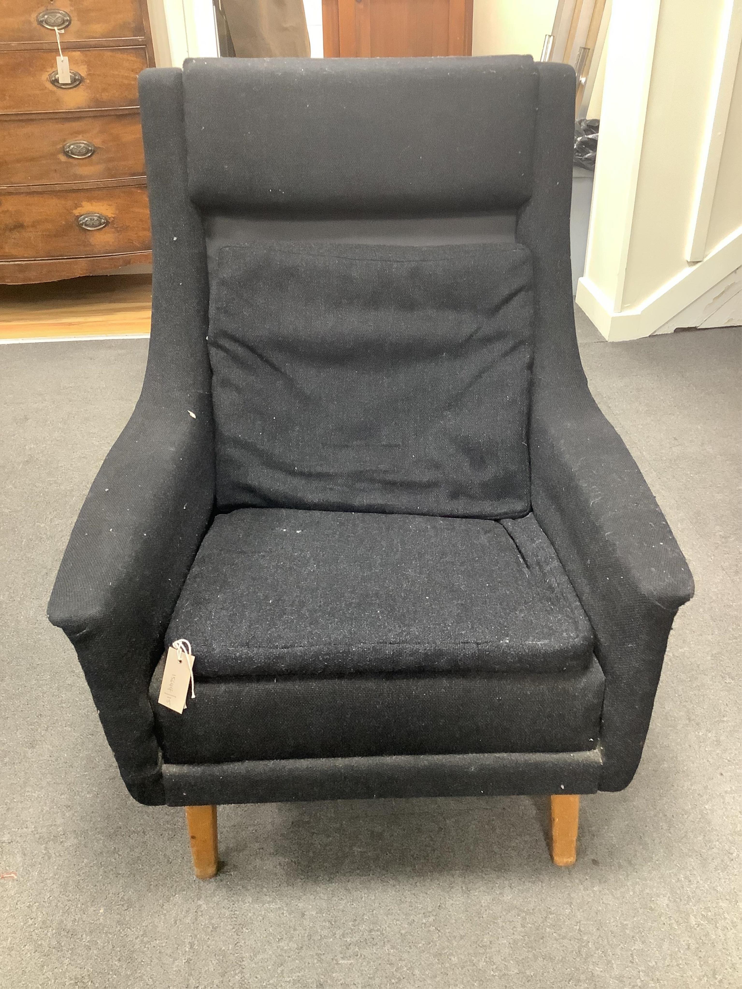 In the manner of Fritz Hansen, a mid century black fabric high back lounge chair, width 76cm, depth 74cm, height 94cm. Condition - fair